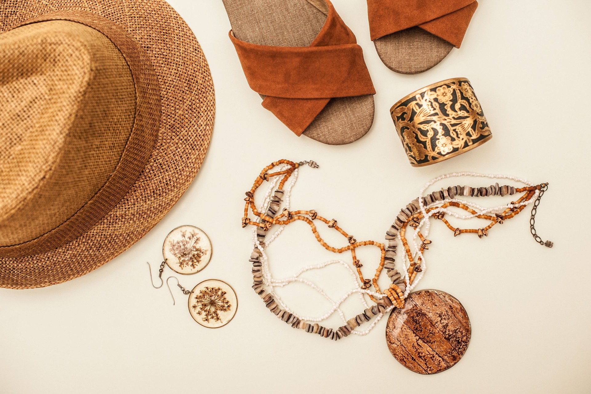 Brown Sandals, Necklace, Straw Hat and Earrings Isolated on White